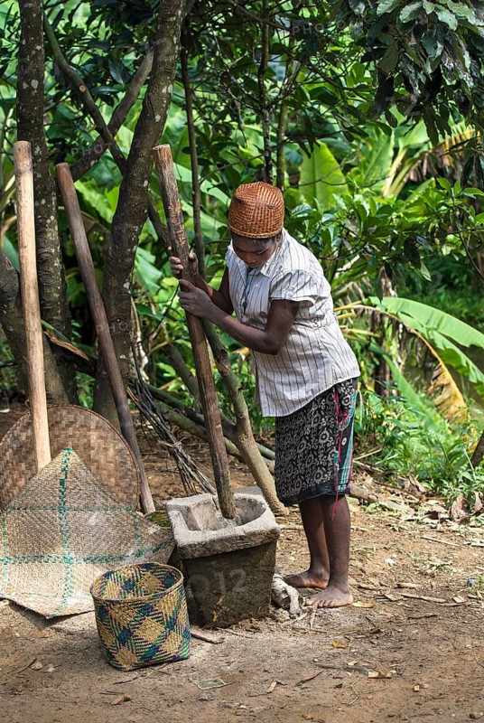 Woman pounding rice