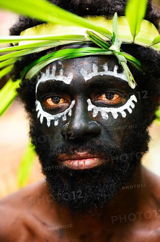 Korafe-Man with facial painting and headdress made of leaves