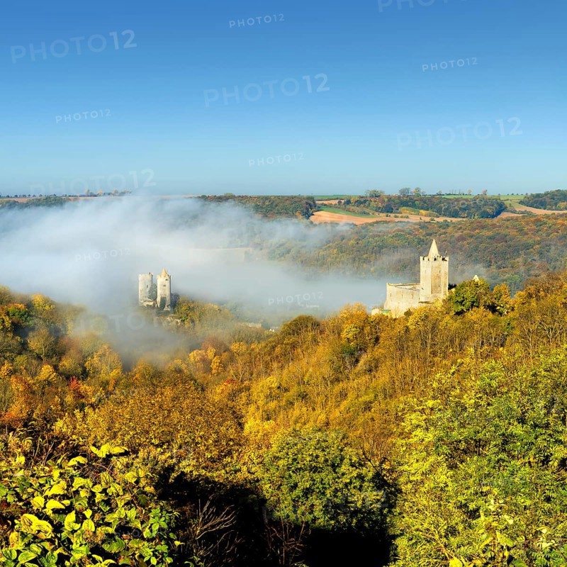 Castle ruins Saaleck and Rudelsburg in the autumn morning mist in the Saaletal valley