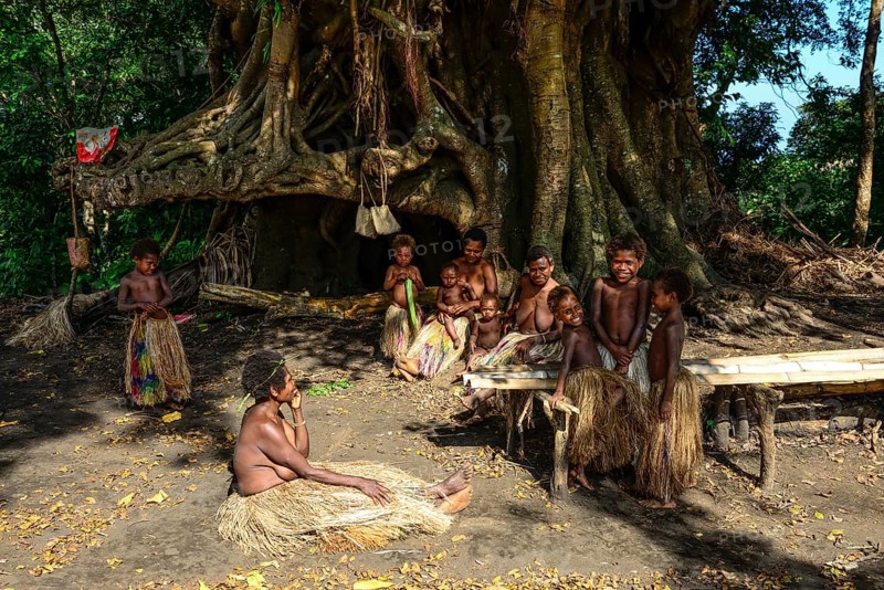 Native women and children sitting together