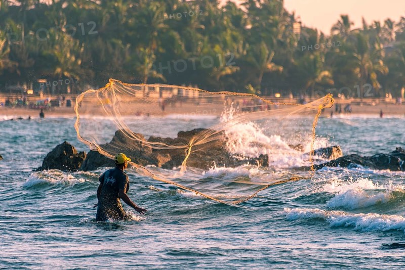 Local fisherman casts fishing net
