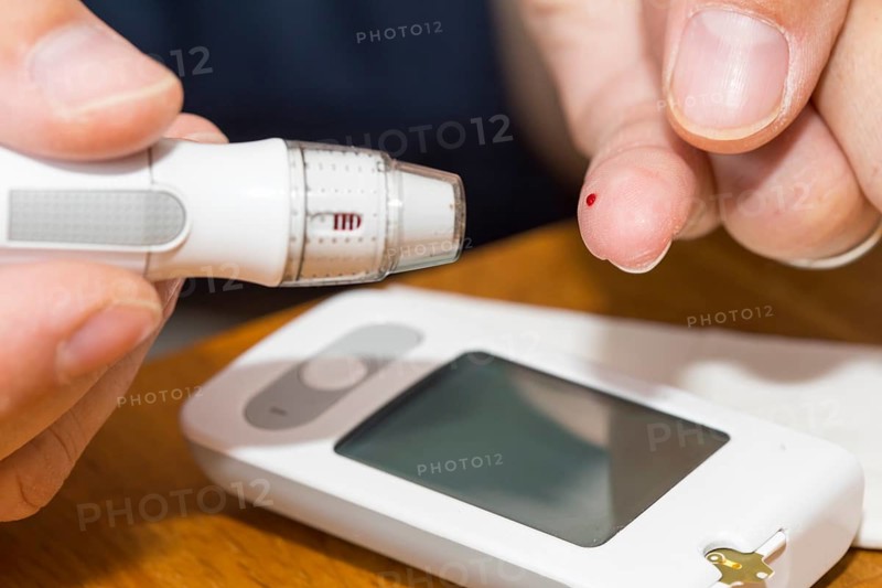 Diabetics taking a blood glucose test