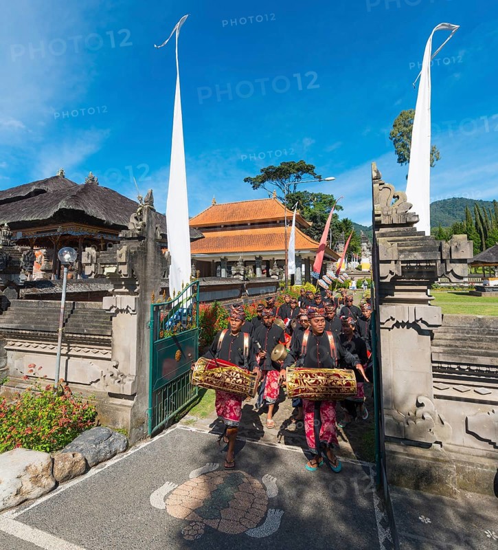 Procession of devout Buddhists at water temple Pura Ulun Danu Bratan water temple