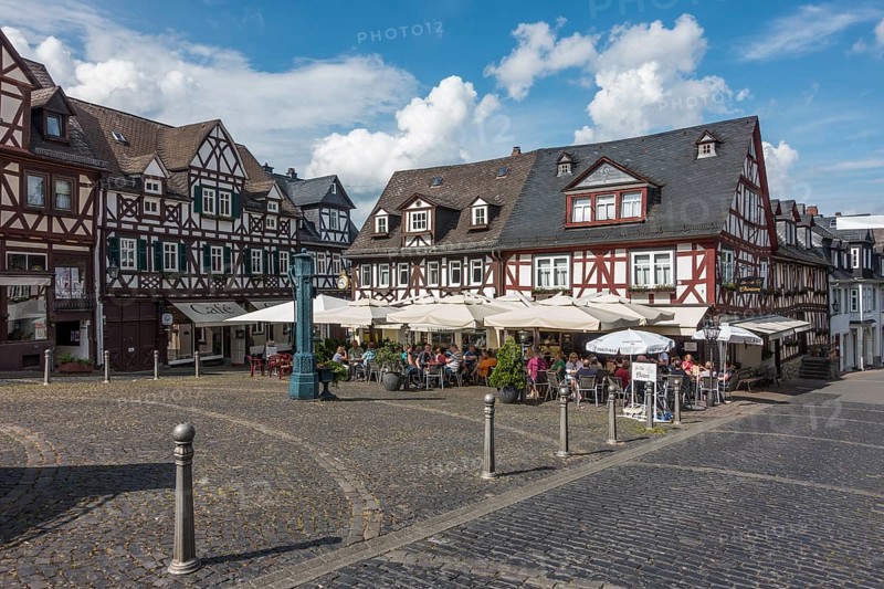 Market square with half-timbered houses and historic water pump