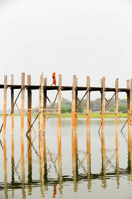 Monk crossing U Bein bridge
