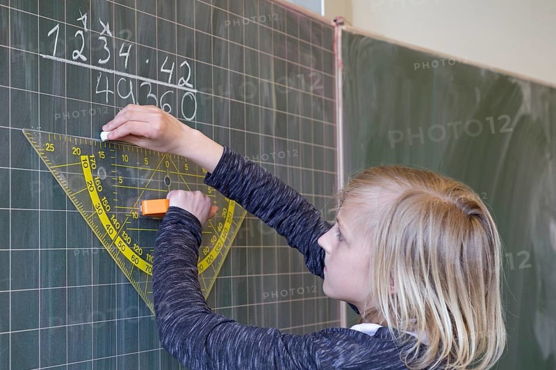 Student calculating on the blackboard