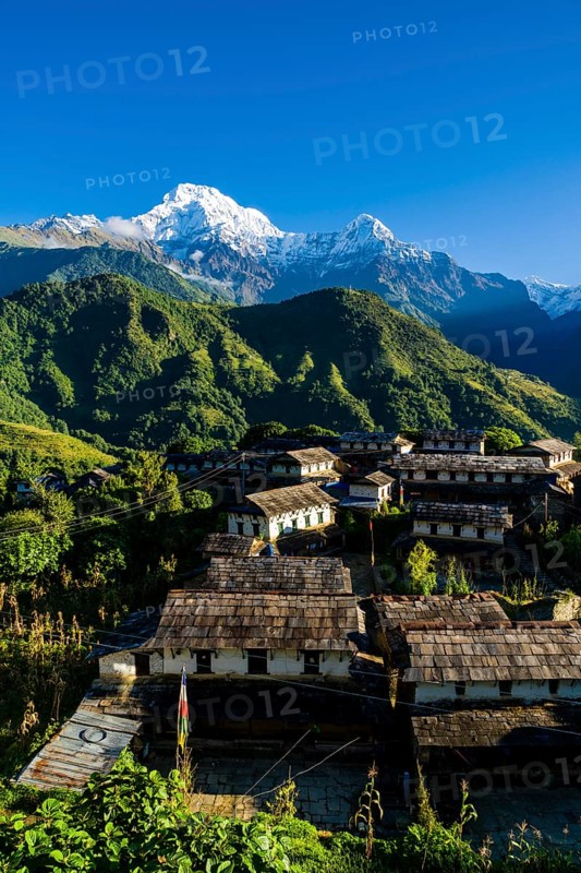 View on the historical village with the mountains Annapurna South
