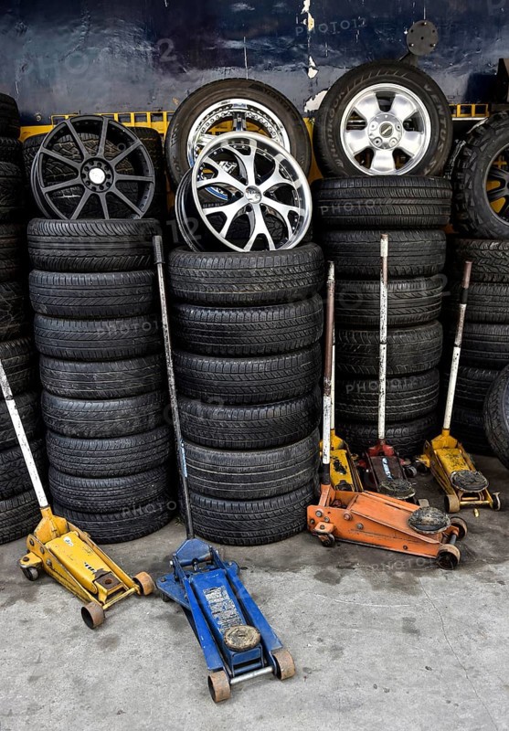Stacked tires and car jacks