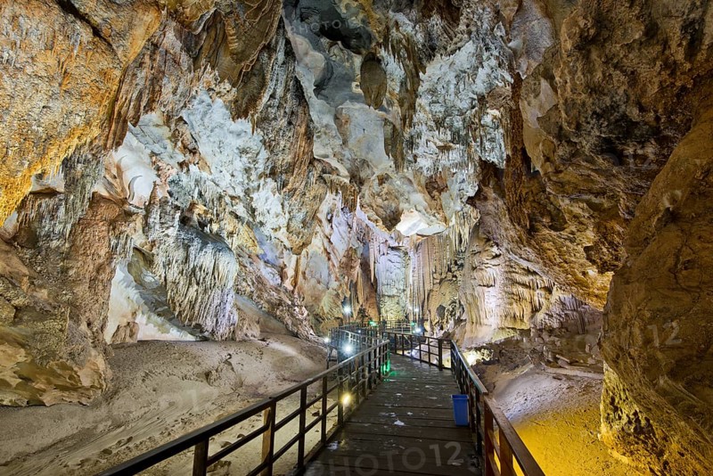 Boardwalk through illuminated dripstone cave