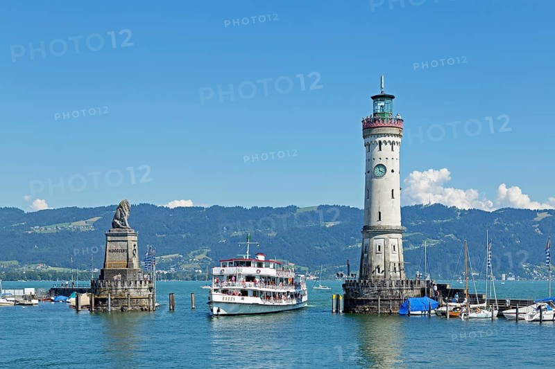 Passenger ship in port entrance with lighthouse in the harbor
