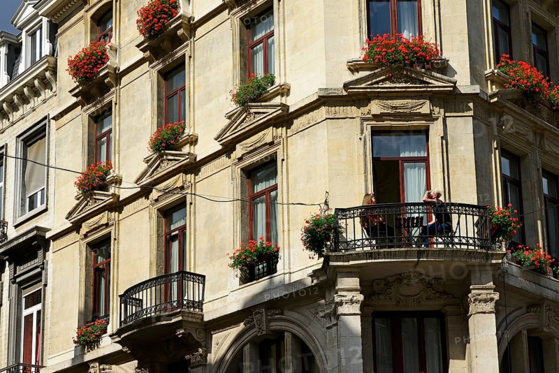 Young woman having breakfast on the balcony