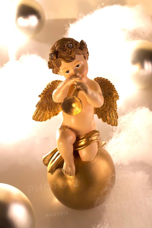 Ceramic angel figure plays trumpet