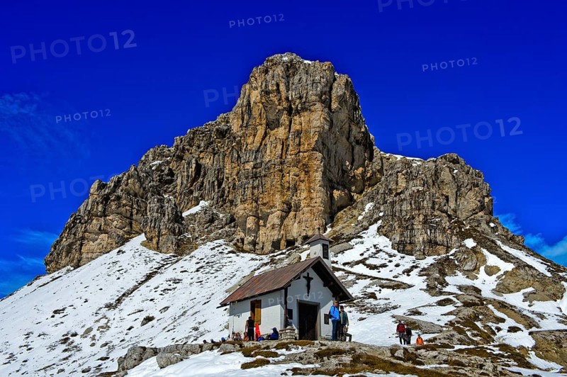 Chapel of Dreizinnenhutte in front of Sextener Stein in snow