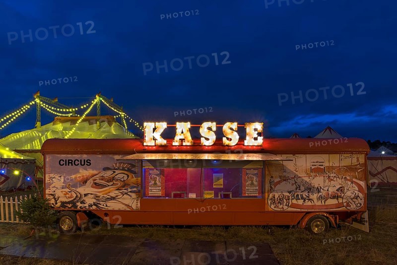 Counter of a travelling circus illuminated at dusk