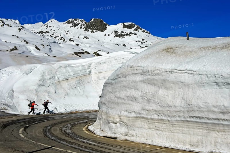 Two skiers in front of high snow walls