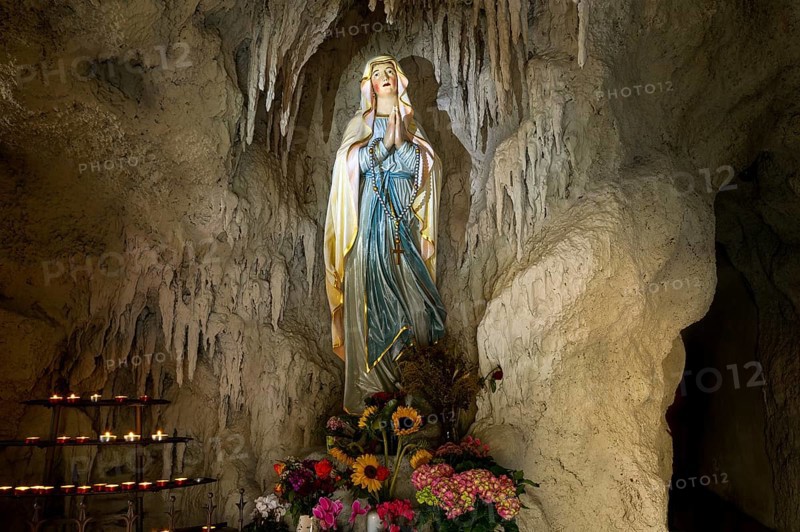 Lourdes grotto with a statue of the Virgin Mary