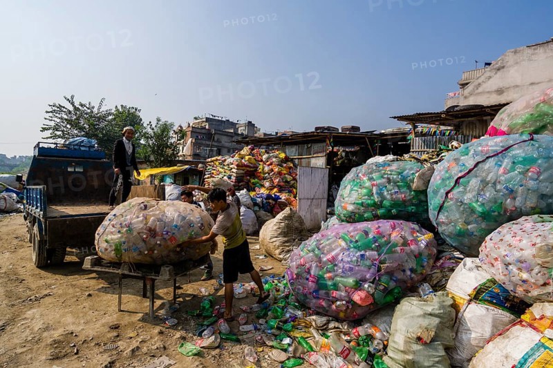 People collecting empty plastic bottles