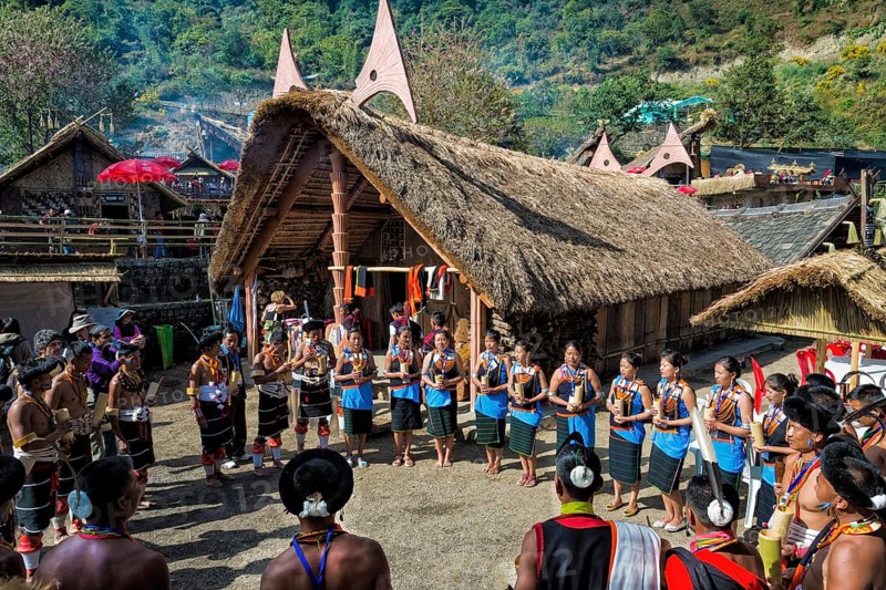 Naga tribes people in front of a traditional house