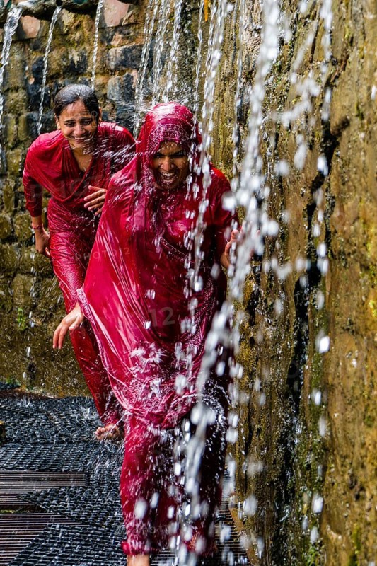 Two female pilgrims running through the 108 holy wells