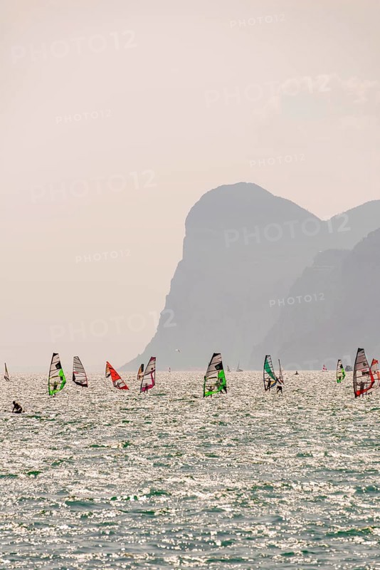 Many windsurfers with colorful sails