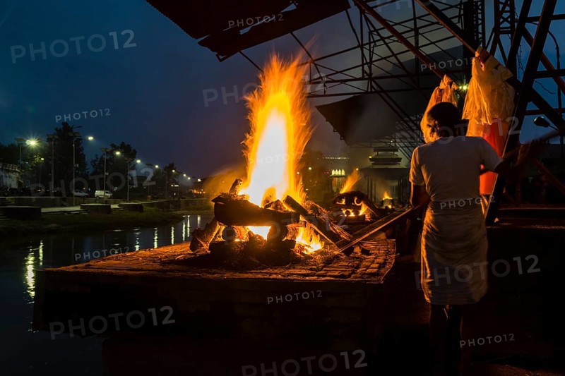 Cremation of a dead body at the burning ghats at night