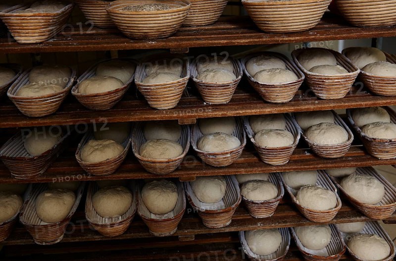 Organic bakery preparing bread loaves in baking baskets