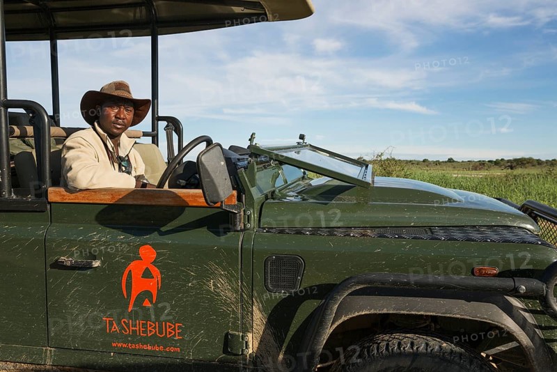A driver and guide in a safari jeep