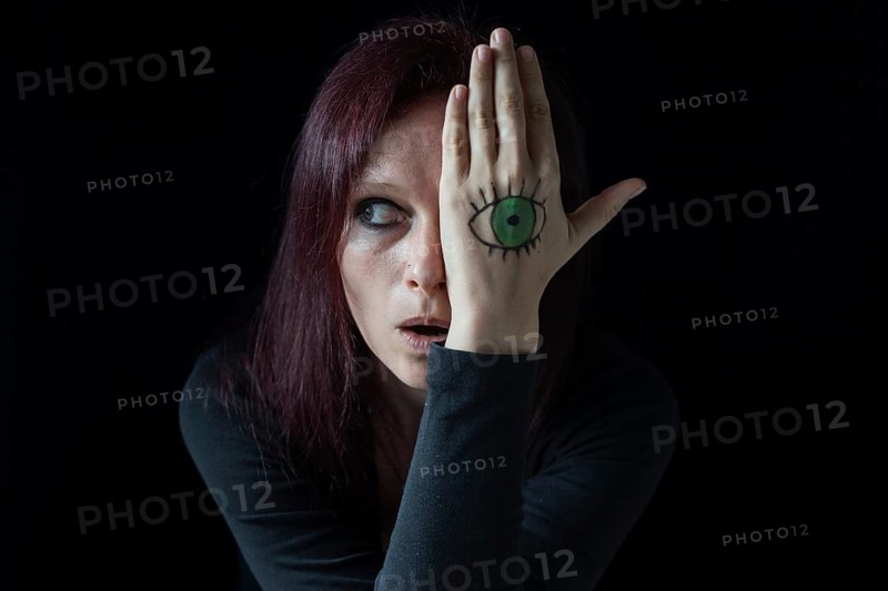 Woman with painted eye on her hands