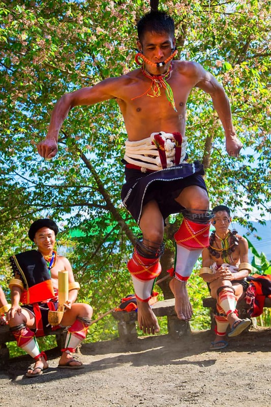 Naga tribal man in traditional outfit performing a warrior dance