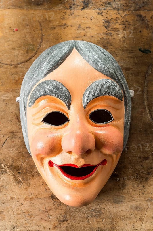Painted wooden mask on a workbench