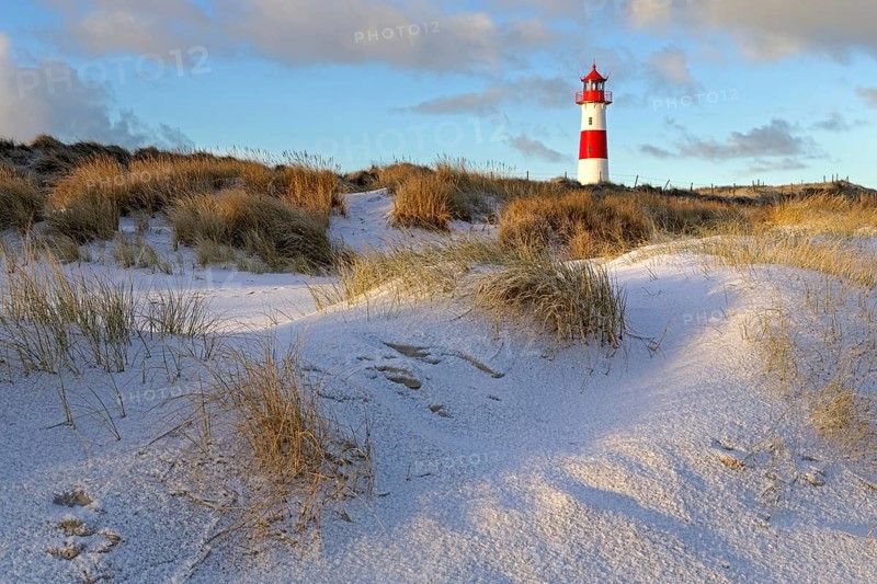 Red and white striped lighthouse List East in the dunes