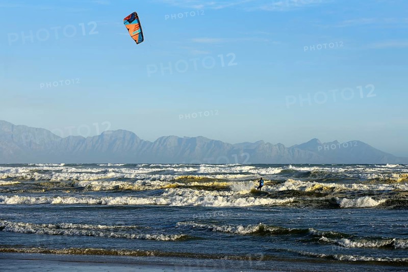 Kitesurfers at high waves