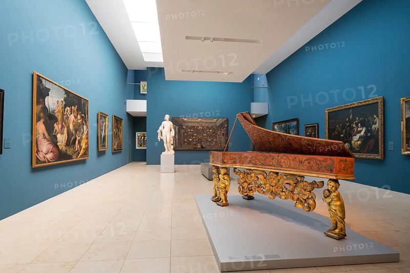 Exhibition space with paintings and harpsichord