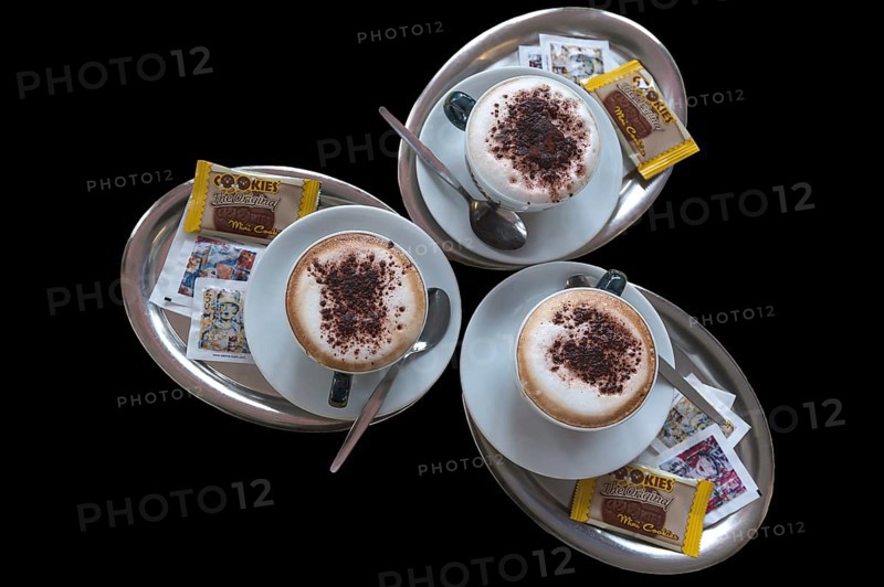 Three cappuccino on silver trays