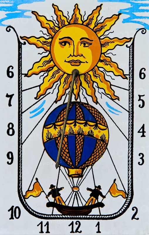Sundial with sun and hot air balloon