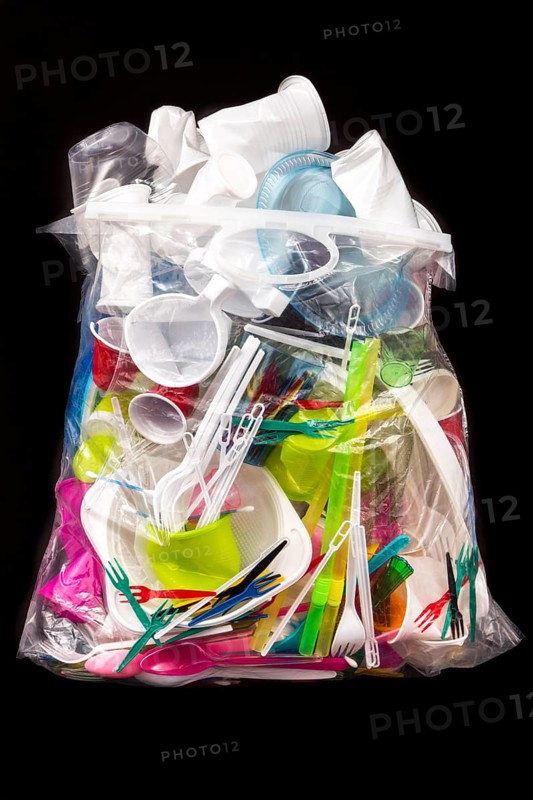 Garbage bag filled with disposable crockery