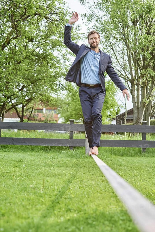 Manager balancing on slackline