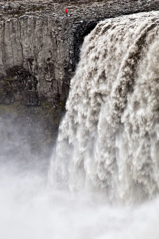 Person at the waterfall Dettifoss