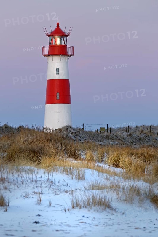 Red and white striped lighthouse List East in the dunes