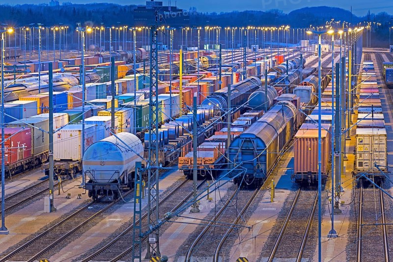 Parked freight cars on tracks at night