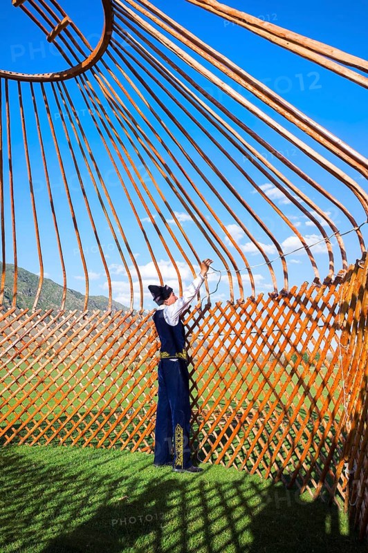Kazakh men putting up a yurt
