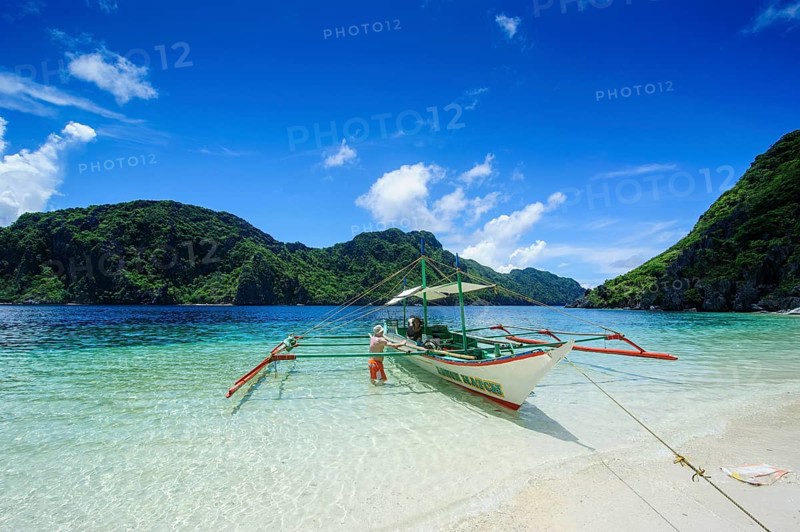 Outrigger boat in the crystal clear water in the Bacuit archipelago