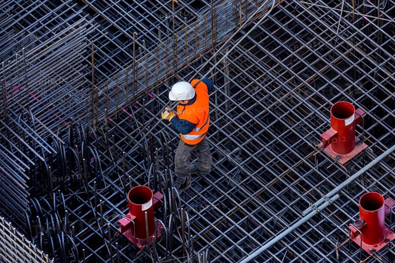 Construction workers processing reinforcing steel for reinforced concrete ceiling