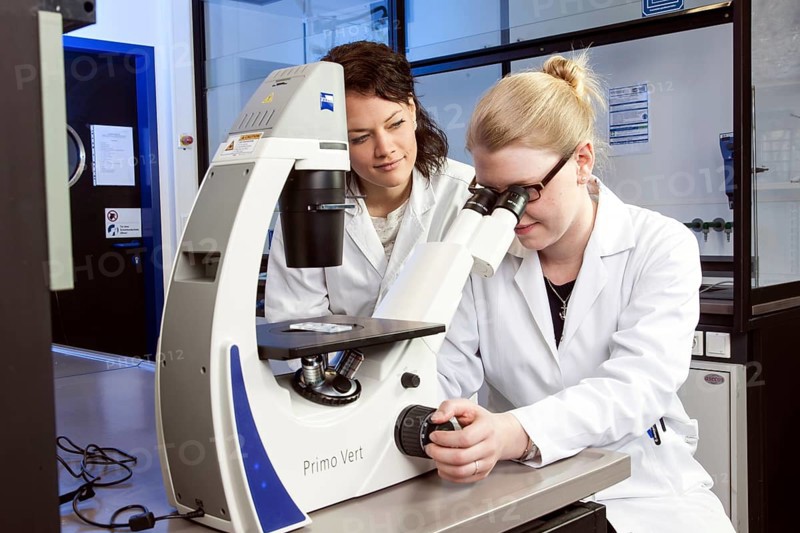 Pharmacist at the microscope in a genetic laboratory