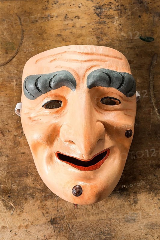 Painted wooden mask on a workbench