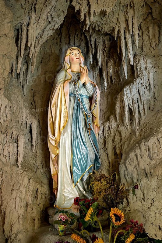 Lourdes grotto with a statue of the Virgin Mary