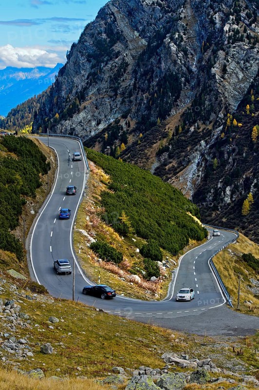Cars on a mountain road in a hairpin curve