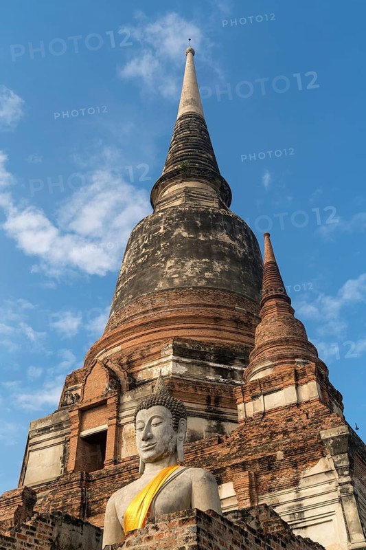 Buddha statue in front of large Chedi