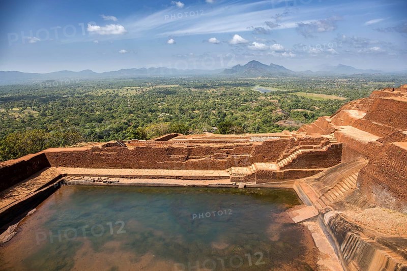 Historic rock fortress with water pool