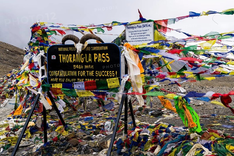 Tibetan prayer flags at sign Thorong-La Pass
